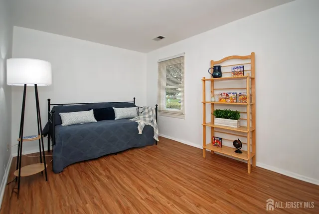 a bedroom with furniture and a wooden floor