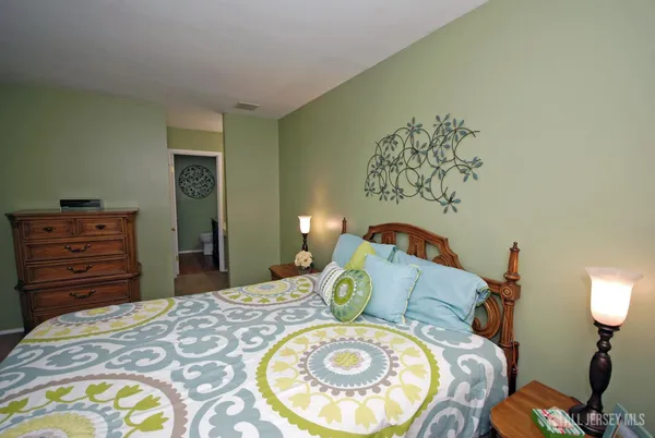 a bedroom with a bed and a tv