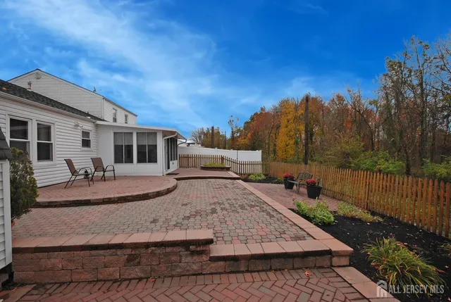 a view of a house with backyard and sitting area