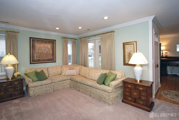 a living room with furniture and a lamp