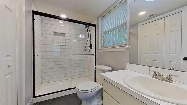 a bathroom with a sink toilet and shower