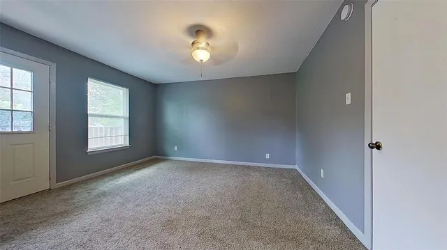 a view of an empty room with a window