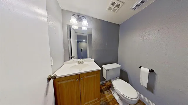 a white toilet sitting next to a bathroom sink