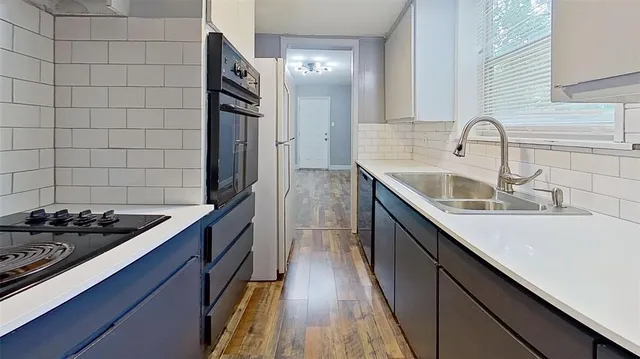a kitchen with sink and stove