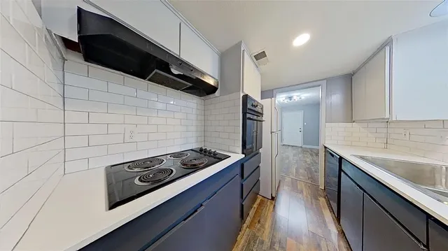 a kitchen with a stove and a sink