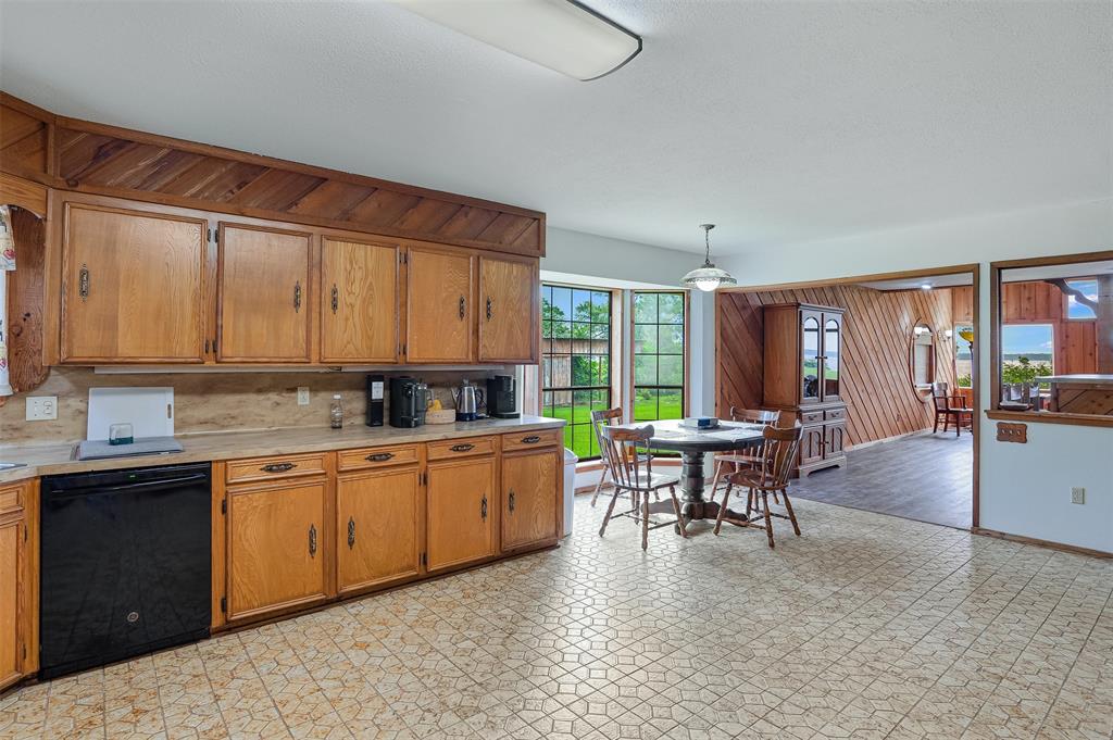10307 Pirogue Road Oil City, LA 71061 - Photo 8 of 36 a kitchen with sink cabinets and dining table chair