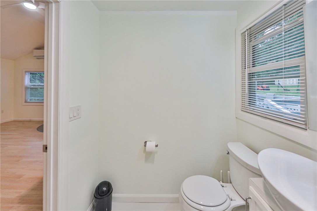 5599 Minks Pond Road Bushkill, PA 18324 - Photo 24 of 64 A compact half-bath provides essential convenience, offering both functionality and streamlined design.