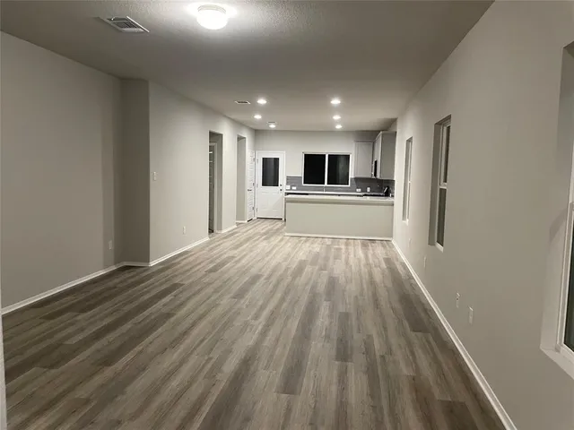 a view of open kitchen with wooden floor