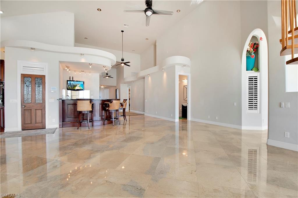 28 West Pelican Street Naples, FL 34113 - Photo 13 of 50 a view of a room with lots of dining table and chairs