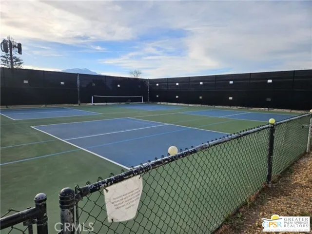 a view of a swimming pool with a patio and a yard
