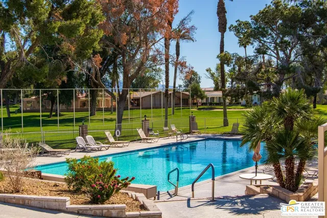 an aerial view of a residential houses with yard