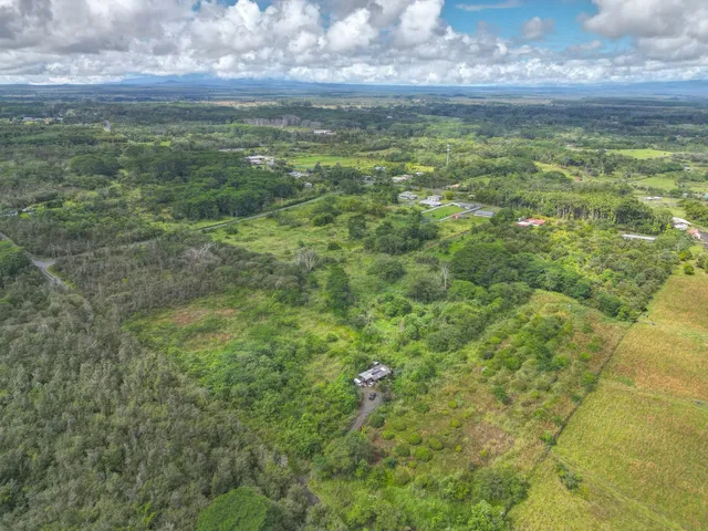 an aerial view of a houses with a yard