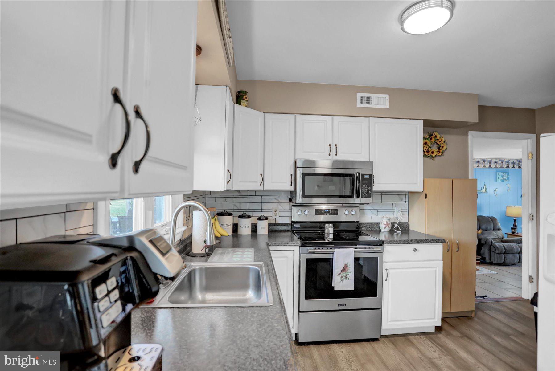 26 West Shortcut Road Newport, PA 17074 - Photo 12 of 37 a kitchen with stainless steel appliances granite countertop a stove a sink and a microwave