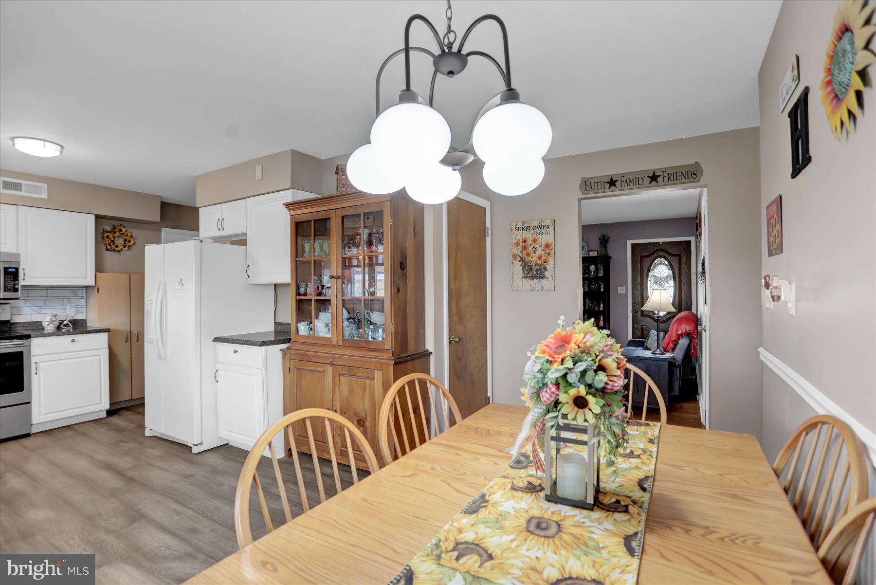26 West Shortcut Road Newport, PA 17074 - Photo 8 of 37 a dining room with wooden floor a chandelier a wooden table and chairs