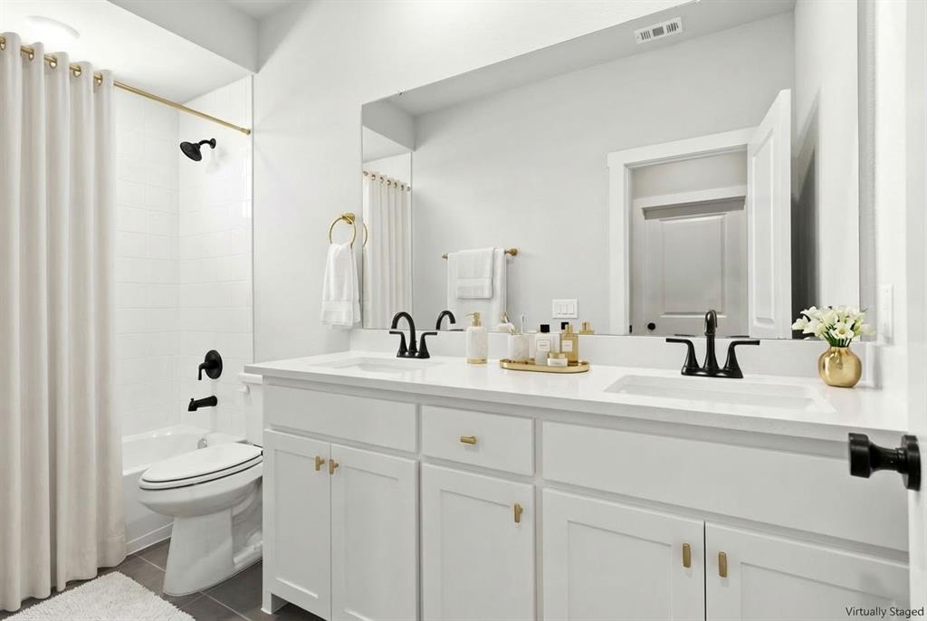 2020 Aldrich Road Celina, TX 75009 - Photo 33 of 40 a bathroom with a sink a toilet and a mirror
