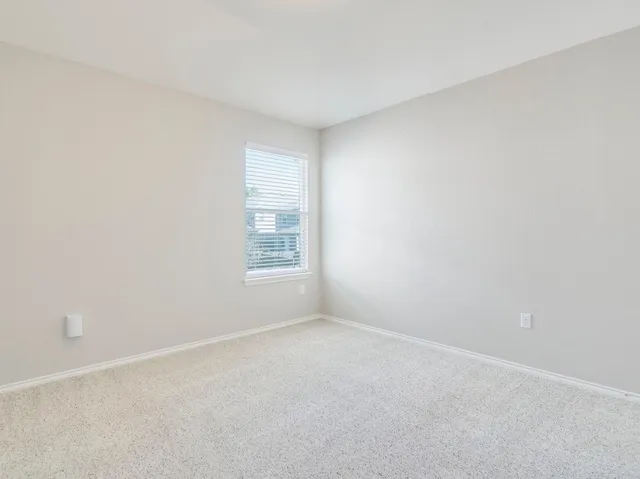 a view of an empty room and closet area