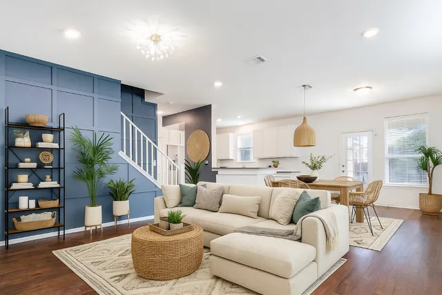 a living room with furniture and a potted plant