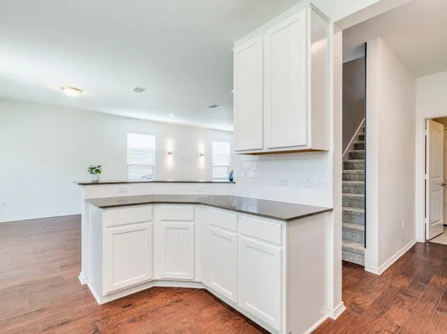 a view of an entryway with wooden floor