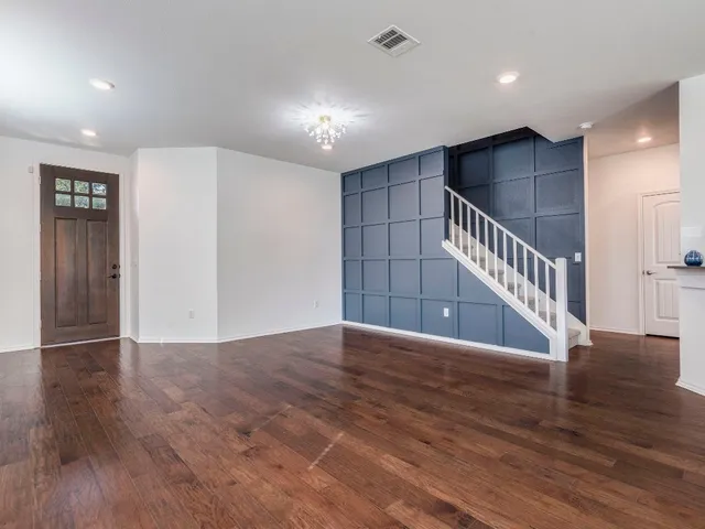 a view of a kitchen with wooden floor and electronic appliances