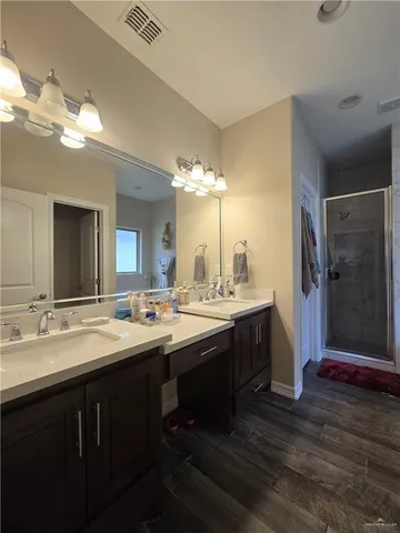 a bathroom with a double vanity sink and a mirror