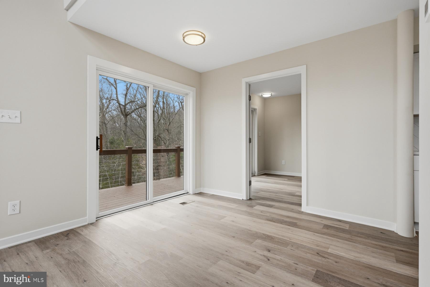 1717 Porters Hill Road Annapolis, MD 21401 - Photo 12 of 27 an empty room with wooden floor and windows