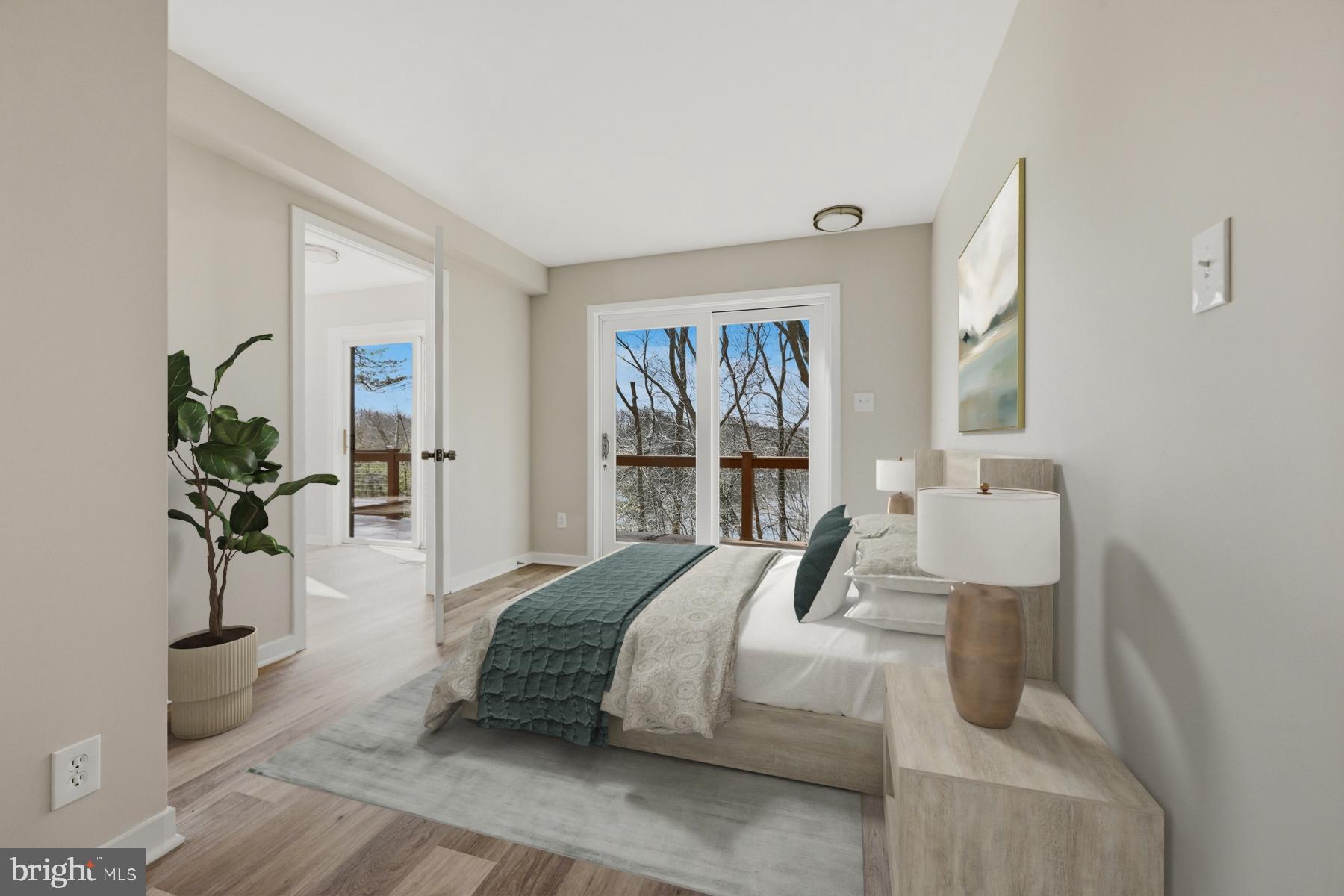 1717 Porters Hill Road Annapolis, MD 21401 - Photo 13 of 27 a bedroom with a large bed and a potted plant