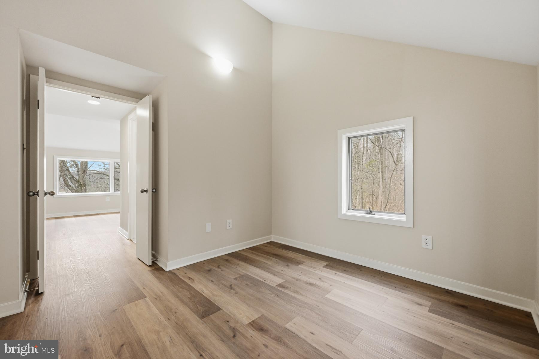 1717 Porters Hill Road Annapolis, MD 21401 - Photo 23 of 27 an empty room with wooden floor and windows