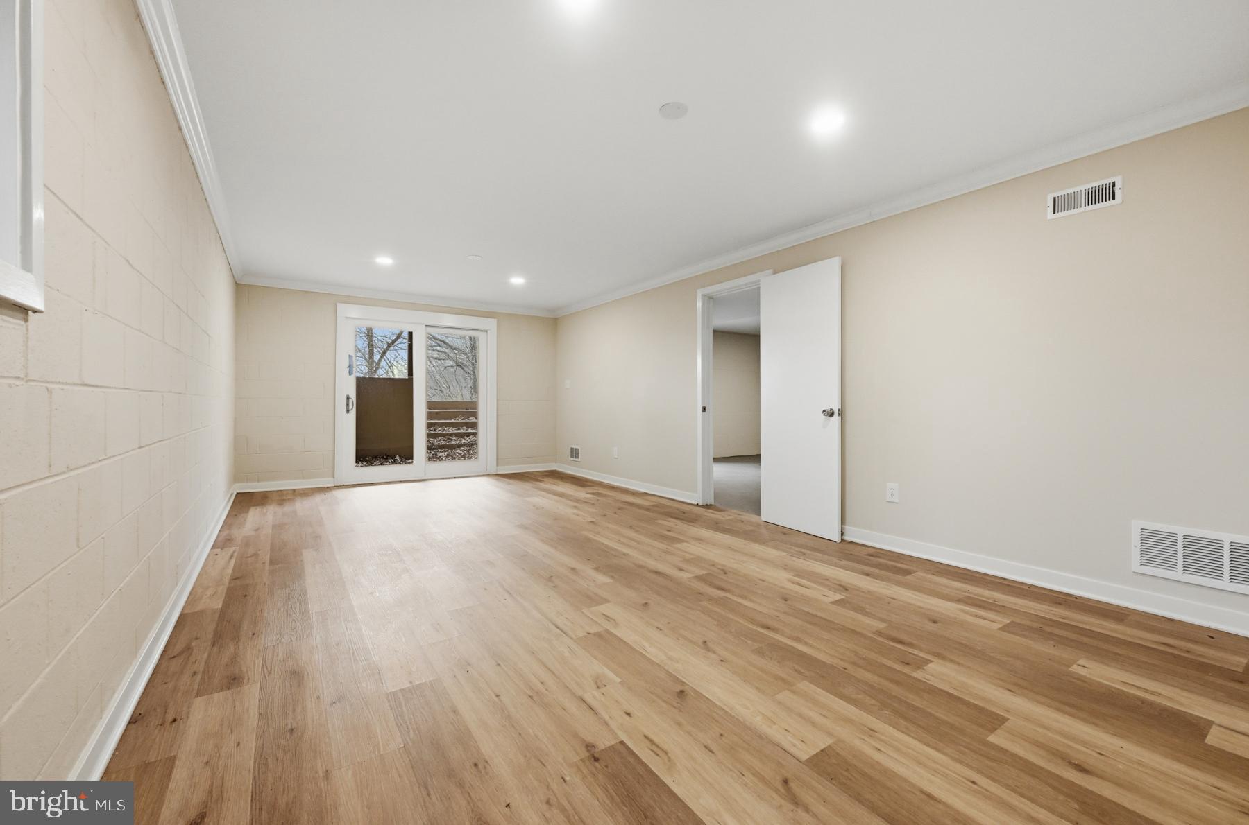 1717 Porters Hill Road Annapolis, MD 21401 - Photo 26 of 27 a view of an empty room with wooden floor and a window