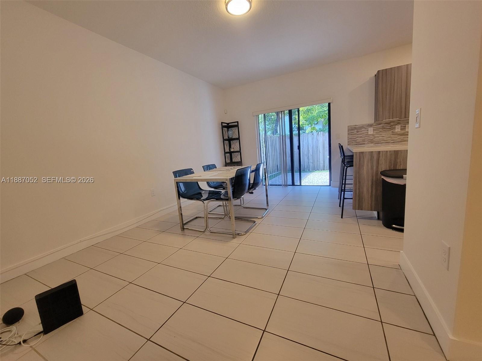 8860 Northwest 103rd Path Doral, FL 33178 - Photo 11 of 52 a living room with furniture a fireplace and a flat screen tv