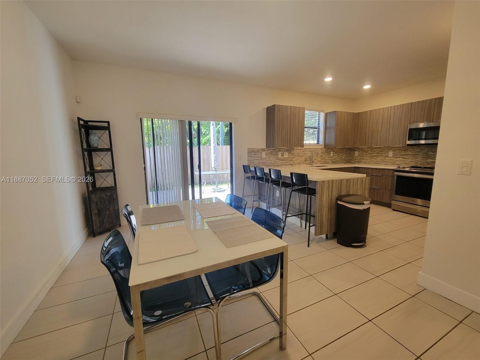 8860 Northwest 103rd Path Doral, FL 33178 - Photo 12 of 52 a kitchen with a stove a sink and a refrigerator