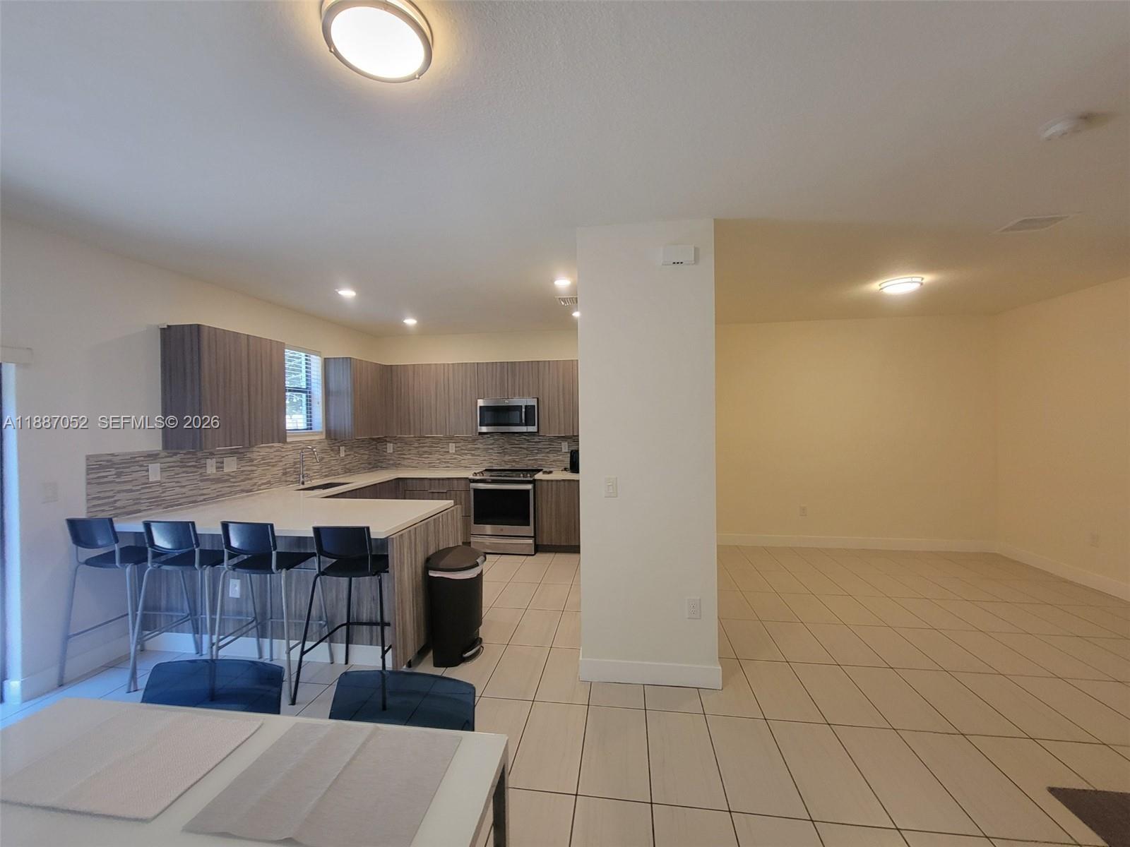 8860 Northwest 103rd Path Doral, FL 33178 - Photo 13 of 52 a kitchen with a sink and cabinets