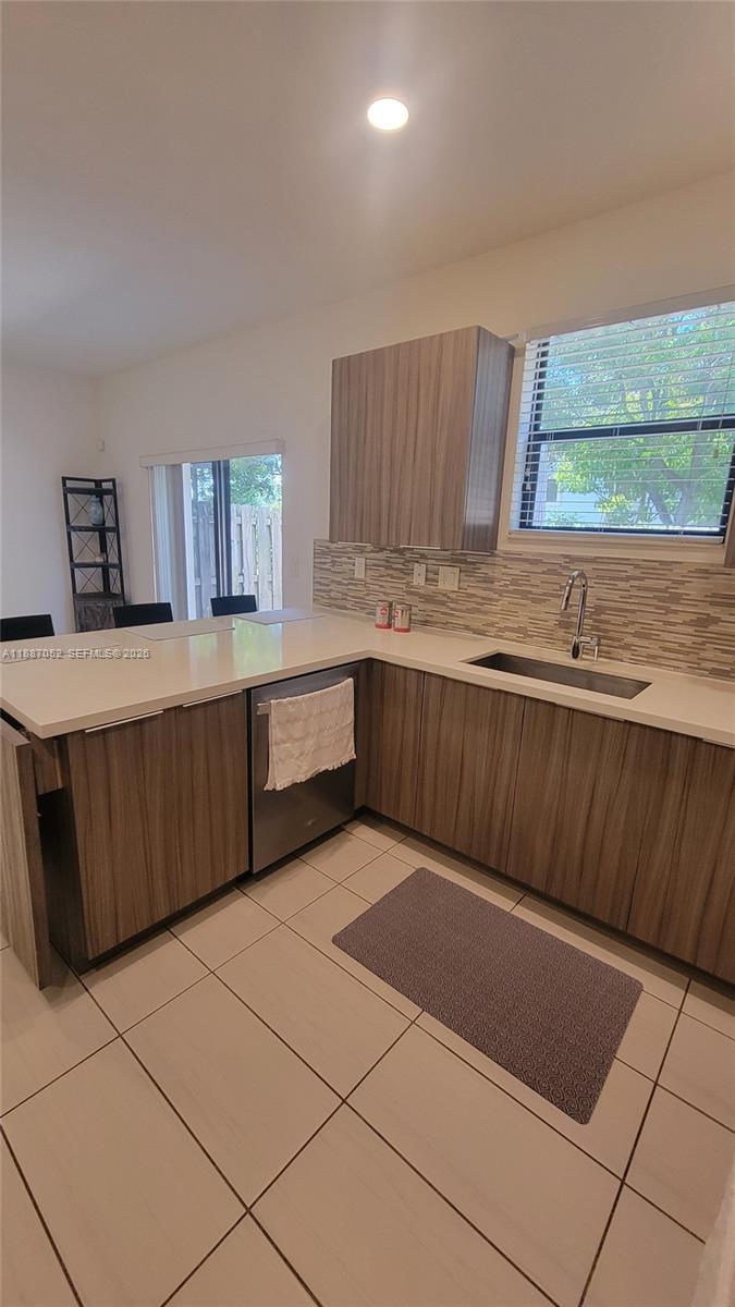 8860 Northwest 103rd Path Doral, FL 33178 - Photo 17 of 52 a kitchen with stainless steel appliances a sink and cabinets