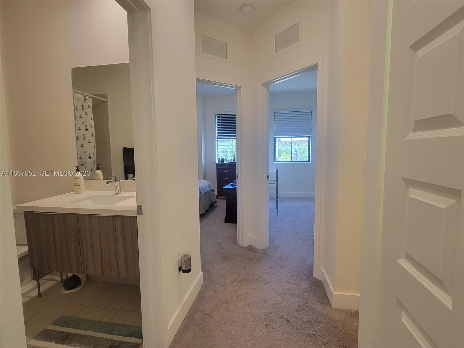 8860 Northwest 103rd Path Doral, FL 33178 - Photo 30 of 52 a bathroom with a sink and mirror