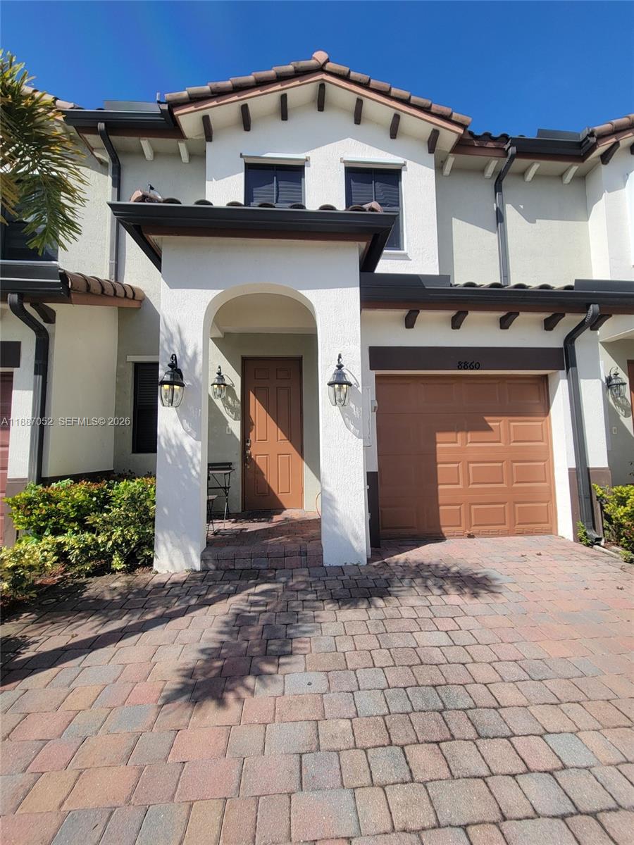 8860 Northwest 103rd Path Doral, FL 33178 - Photo 3 of 52 a front view of a house with a yard