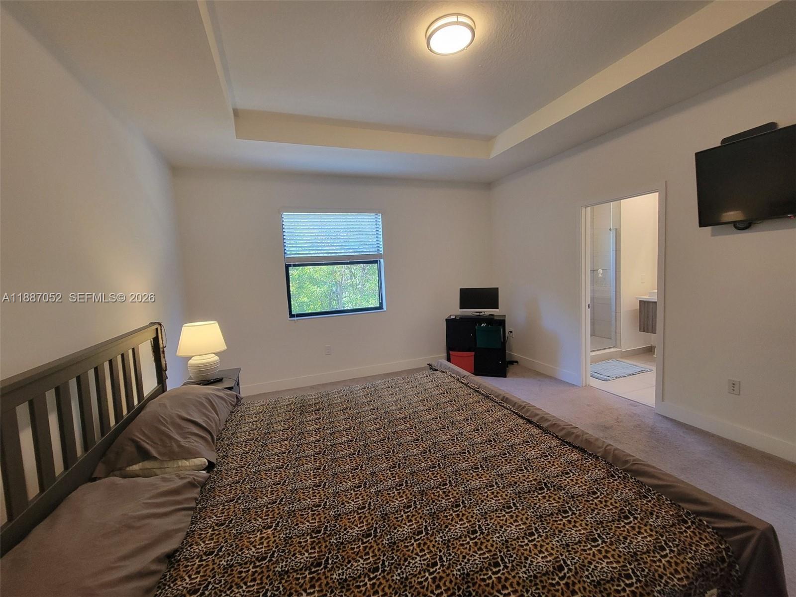 8860 Northwest 103rd Path Doral, FL 33178 - Photo 33 of 52 a bedroom with a bed and a television