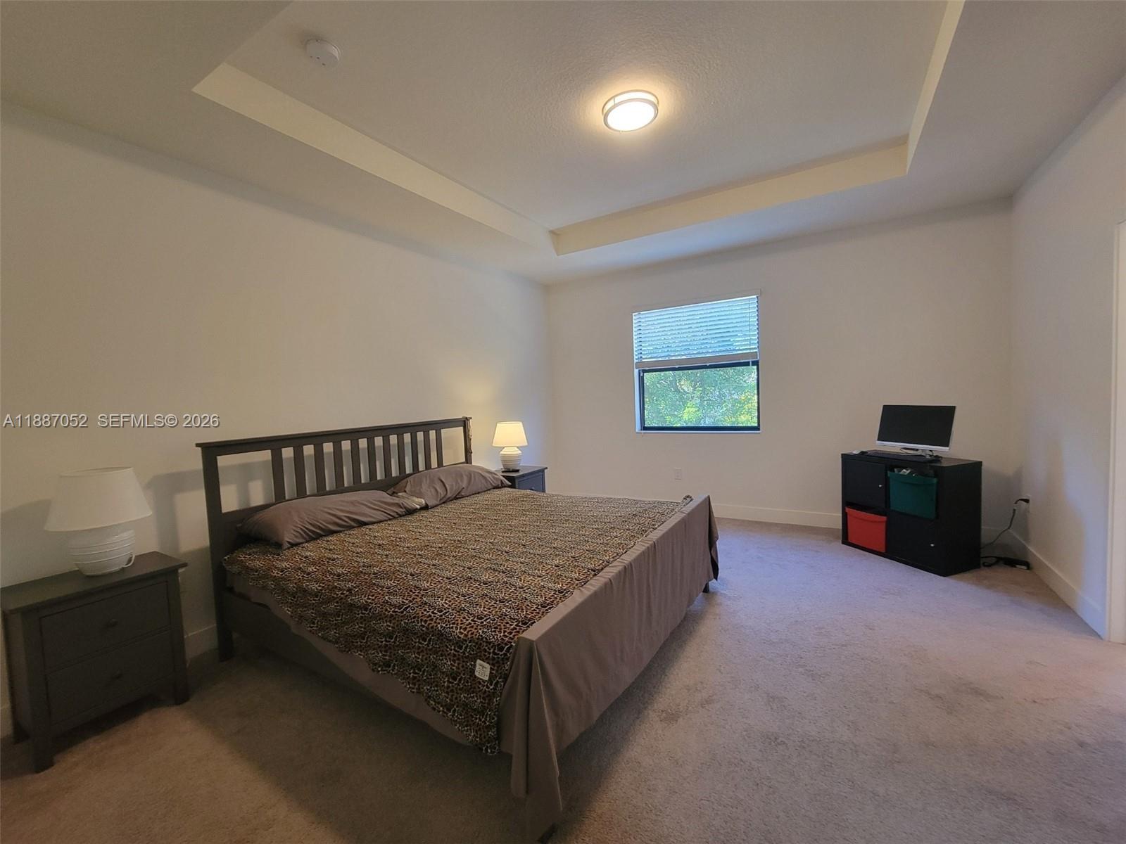 8860 Northwest 103rd Path Doral, FL 33178 - Photo 34 of 52 a bed room with a bed and a television