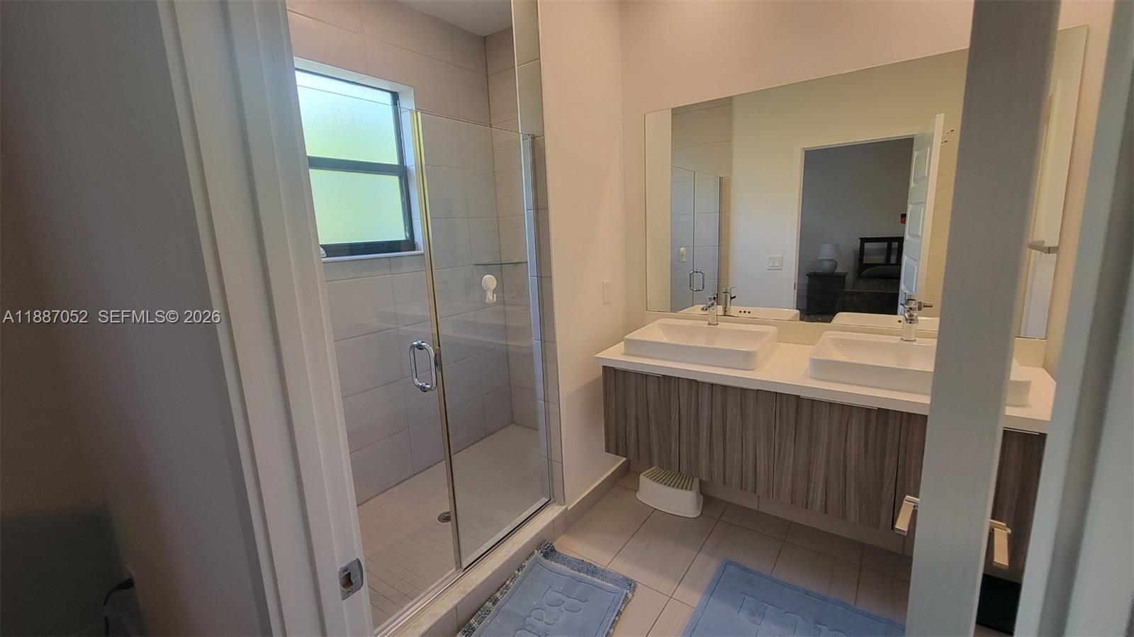 8860 Northwest 103rd Path Doral, FL 33178 - Photo 36 of 52 a bathroom with a sink and a mirror