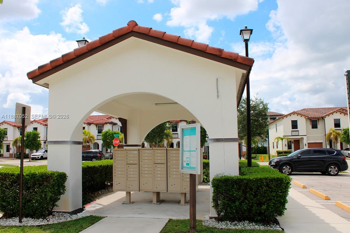 8860 Northwest 103rd Path Doral, FL 33178 - Photo 40 of 52 a front view of a house with a yard
