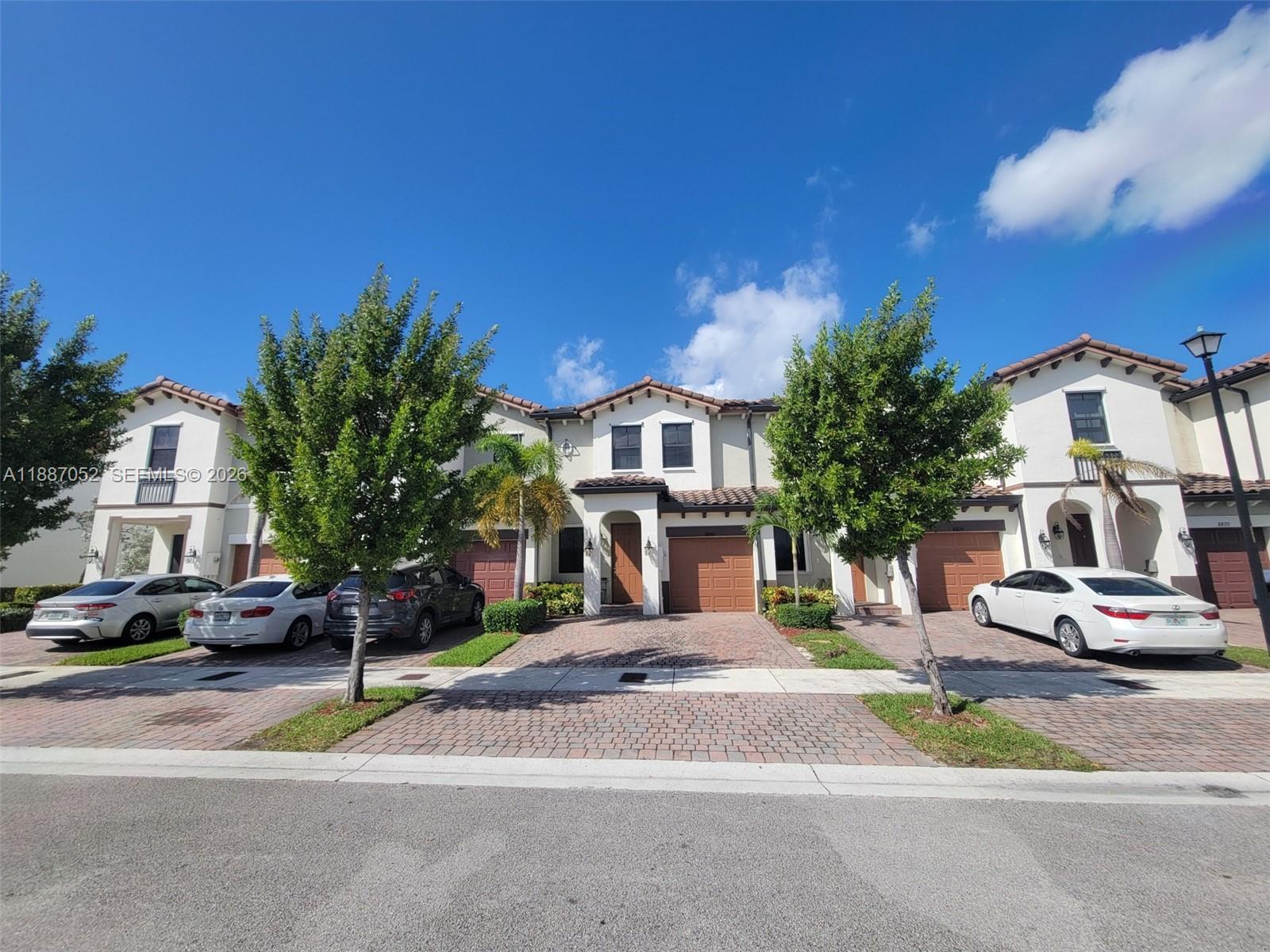 8860 Northwest 103rd Path Doral, FL 33178 - Photo 52 of 52 a front view of a building with a garden and plants