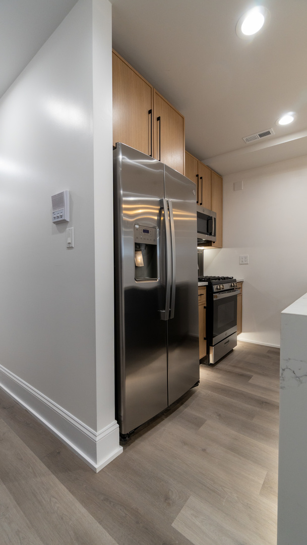 4745 North Beacon Street, Unit GS Chicago, IL 60640 - Photo 13 of 43 a kitchen with granite countertop a refrigerator and a sink
