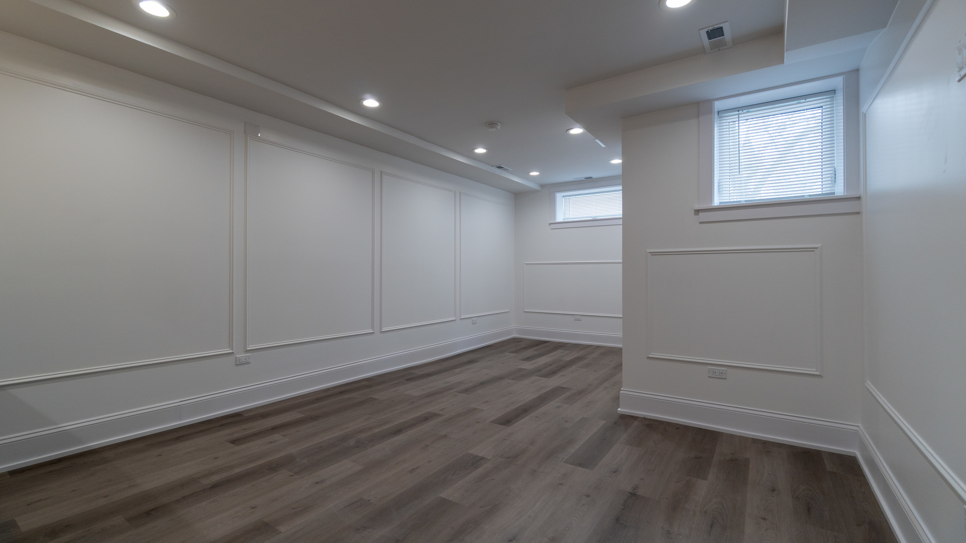 4745 North Beacon Street, Unit GS Chicago, IL 60640 - Photo 21 of 43 an empty room with wooden floor and windows