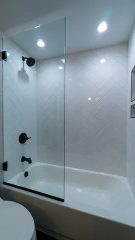 a bathroom with a bathtub and a shower