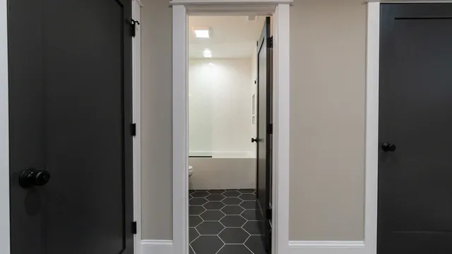 a bathroom with a granite countertop sink a toilet and shower