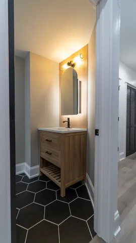 a bathroom with a toilet a sink and mirror