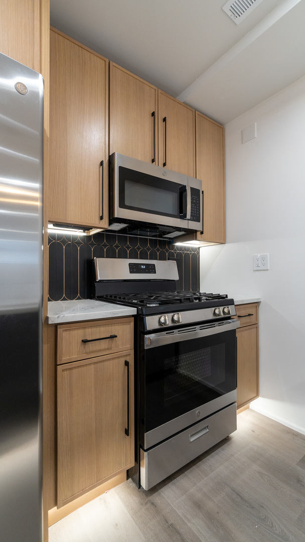 4745 North Beacon Street, Unit GS Chicago, IL 60640 - Photo 4 of 43 a kitchen with a stove and a microwave