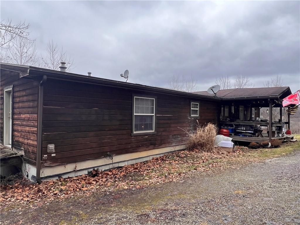 297 Oden Road Ruffs Dale, PA 15679 - Photo 8 of 24 a view of a house with a patio and a yard