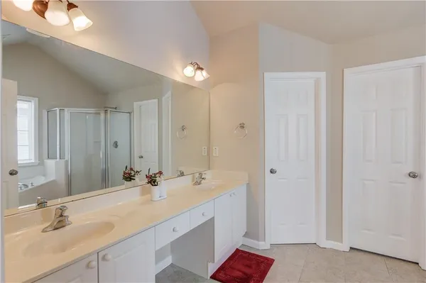 a spacious bathroom with a double vanity sink mirror and
