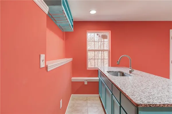 a kitchen with stainless steel appliances granite countertop a sink and a stove