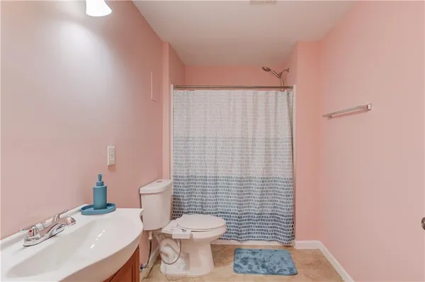 a bathroom with a sink a toilet and mirror