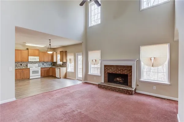 a view of a livingroom with an empty space and a fireplace